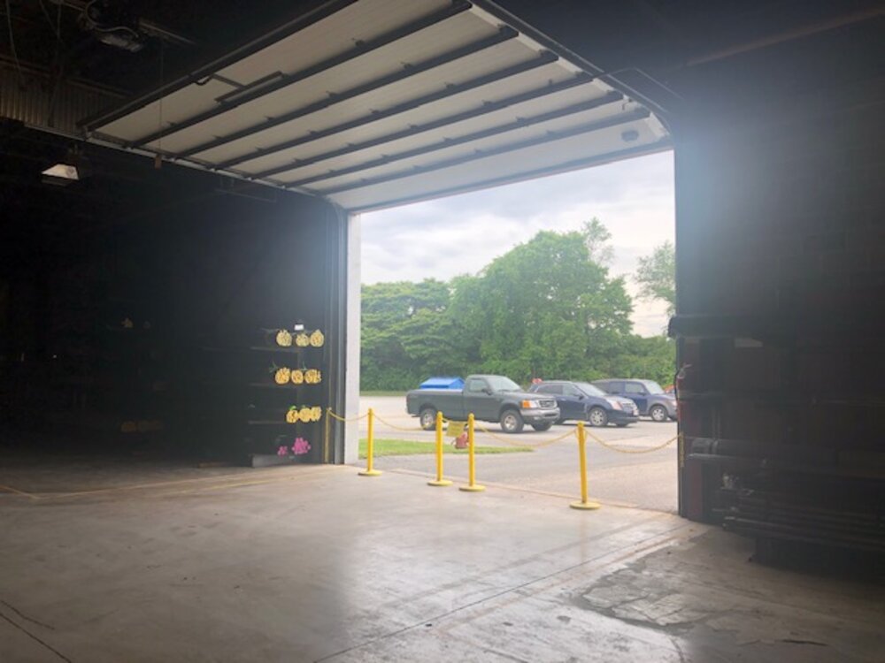 Open overhead door looking out to the parking lot